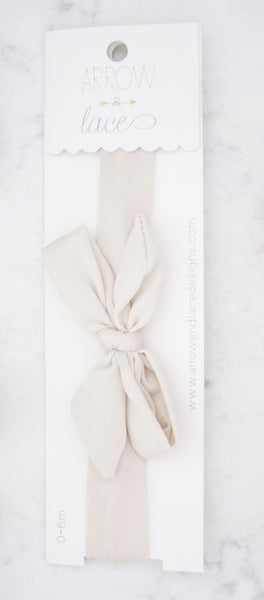 Beige headband in packaging on a white background