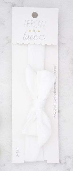 White lace trim packaging with  branding on a marble surface